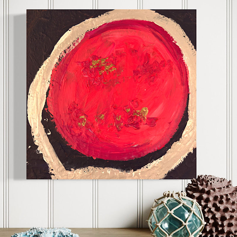 Clara Woods holding Little Mars original painting in her studio, red and pink planet with gold leaf, 12x12 in, 2026