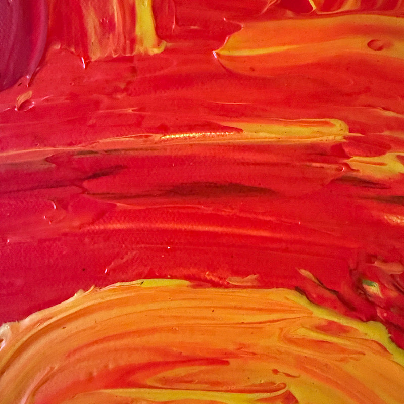 Little Sun original painting by Clara Woods hanging on white paneled wall, 16x12 in, bold yellow and red acrylic sun rays, styled with coastal decor