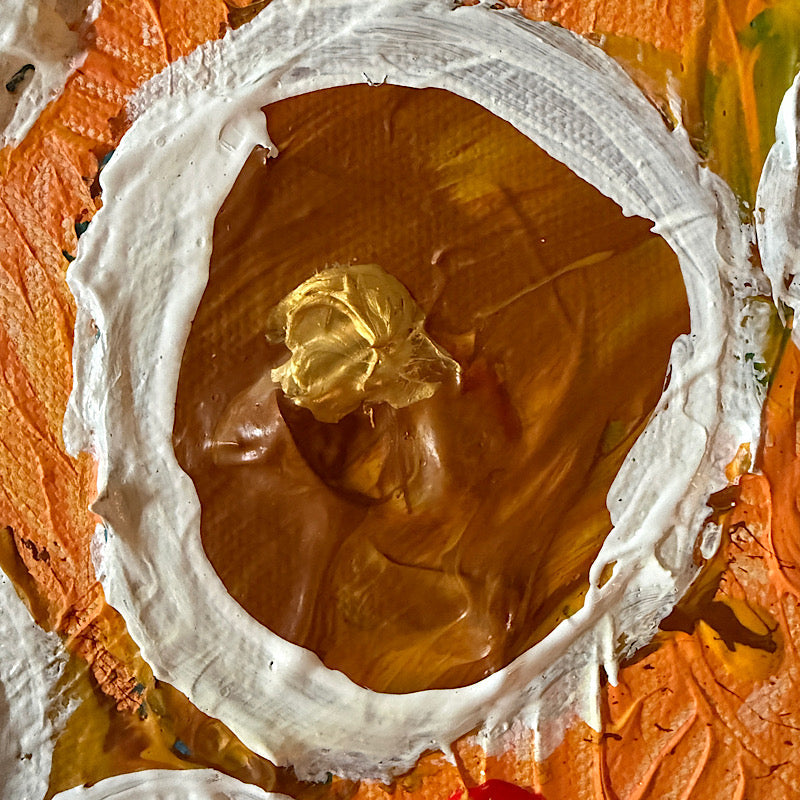 Little Saturn original painting by Clara Woods hanging on white paneled wall, 16x12 in, orange and gold canvas with white impasto ring motifs, styled with coastal decor