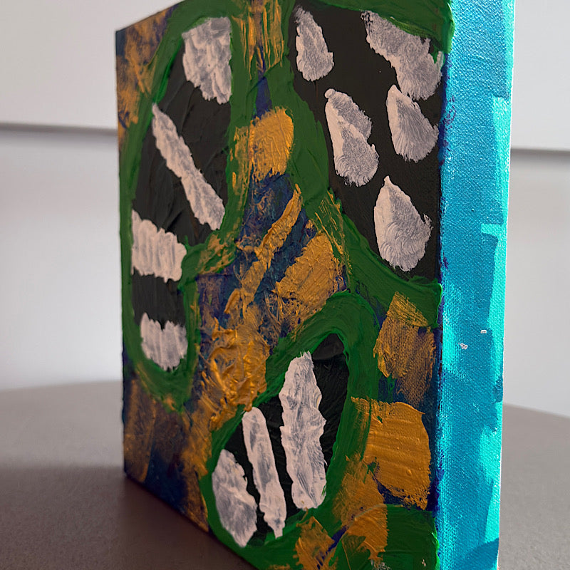 Little Earth original painting by Clara Woods hanging on white paneled wall, 16x16 in, vibrant green swirls with white impasto clouds and gold and blue acrylic, styled with coastal decor