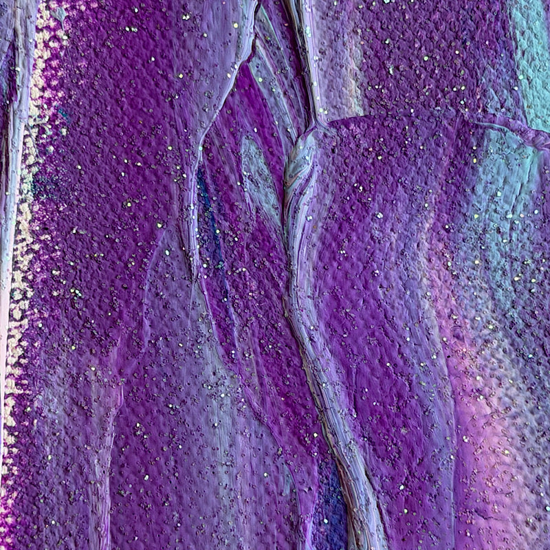 Little Ocean 02 held by Clara Woods at the beach, ocean waves in the background, showing full canvas with violet and blue vertical strokes