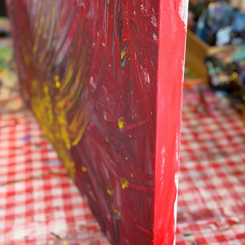 Coral, Original by Clara Woods — side view of the canvas in Clara's studio, showing the depth of the red and magenta paint on the edges