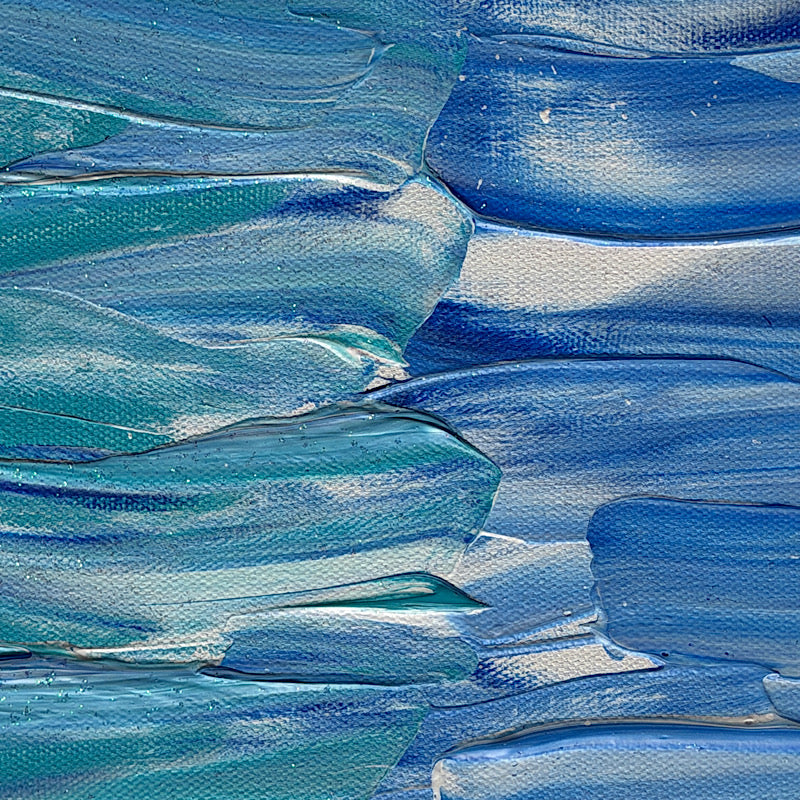 Beach, Original by Clara Woods — side view of the canvas in the studio on a checkered tablecloth, showing the depth of the sky blue and teal layered acrylic paint on the edges