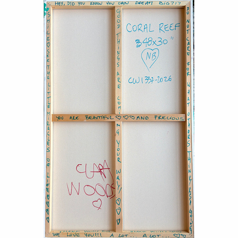 Coral Reef, Original by Clara Woods — displayed on a white wall above a teal sofa with a cream round pillow and a black ceramic lamp on a marble side table with books, contemporary living room