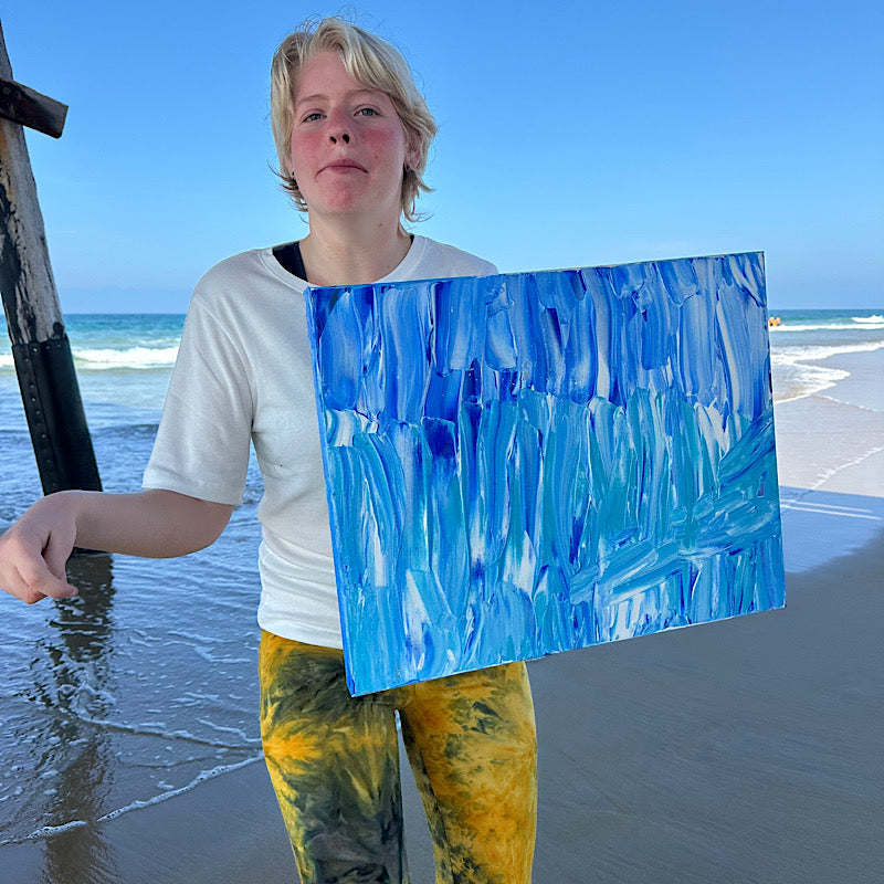 Beach, Original by Clara Woods — back of the canvas showing title BEACH, serial number CW1334-2026, size 16x20 in, Clara Woods signature with NB heart, and handwritten messages: You are loved and beautiful! Be positive! You are precious! Spread love and kindness.