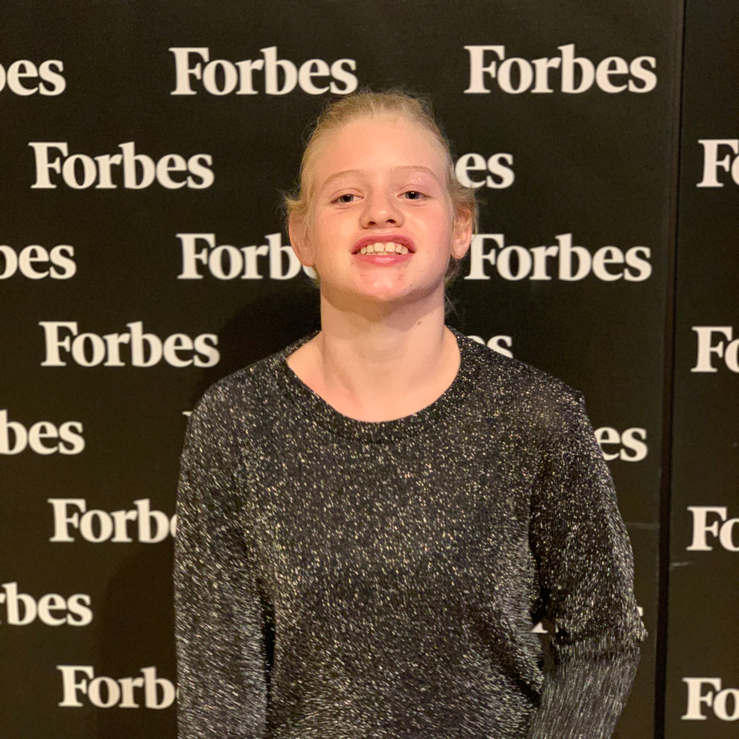 Person standing in front of a Forbes backdrop